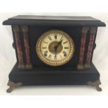 A slate style wooden cased mantle clock with marble look column detail.