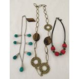 3 necklaces and a brooch, all set with natural stones.