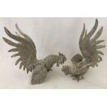 A pair of pewter fighting cock figures.