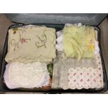 An suitcase full of vintage linen, lace & embroidery items.