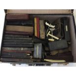 A black suitcase containing a large amount of gents vintage shaving items.