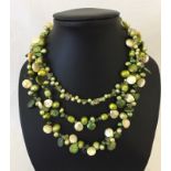 A boxed Pia green tone pearl & semi-precious stone 3 strand necklace.