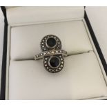 Silver dress ring set with 2 black onyx stones.