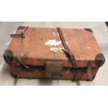 A vintage travelling trunk / case with leather straps and corners.