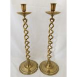 A large pair of antique heavy brass candlesticks with twisted stems.