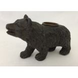 A vintage pewter brown bear with compartment on his back.