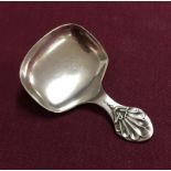 A silver tea caddy spoon with shell design to handle.