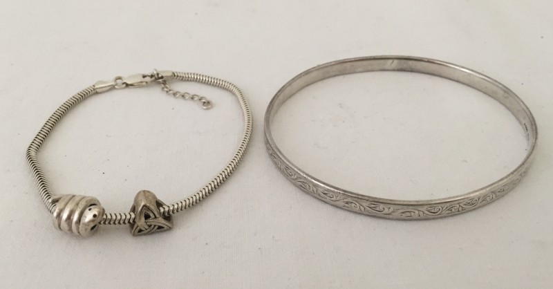2 silver bracelets.
