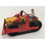 An unboxed Marx tinplate clockwork bulldozer with driver.