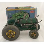 A boxed Mettoy tinplate farm tractor.