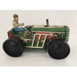 An unboxed Marx tinplate clockwork tractor with driver.