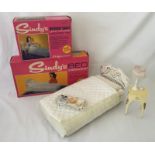 A boxed Sindy bed together with a boxed bedside table, light up lamp and breakfast tray.