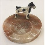 A cold painted bronze Terrier dog standing on a marble ashtray.