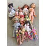 A quantity of vinyl, plastic and porcelain dolls.