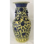 A decorative yellow and blue Chinese vase with pairs of Chilong (dragons) and Shishi (lions).