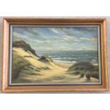 A framed oil on board of a coastal beach scene.