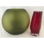 A green etched art glass vase together with a red art glass vase.