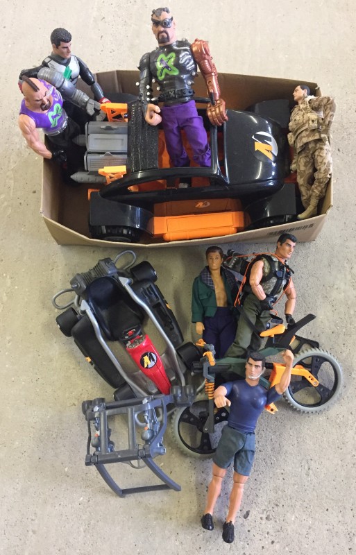 A box of modern Action man figures and accessories.