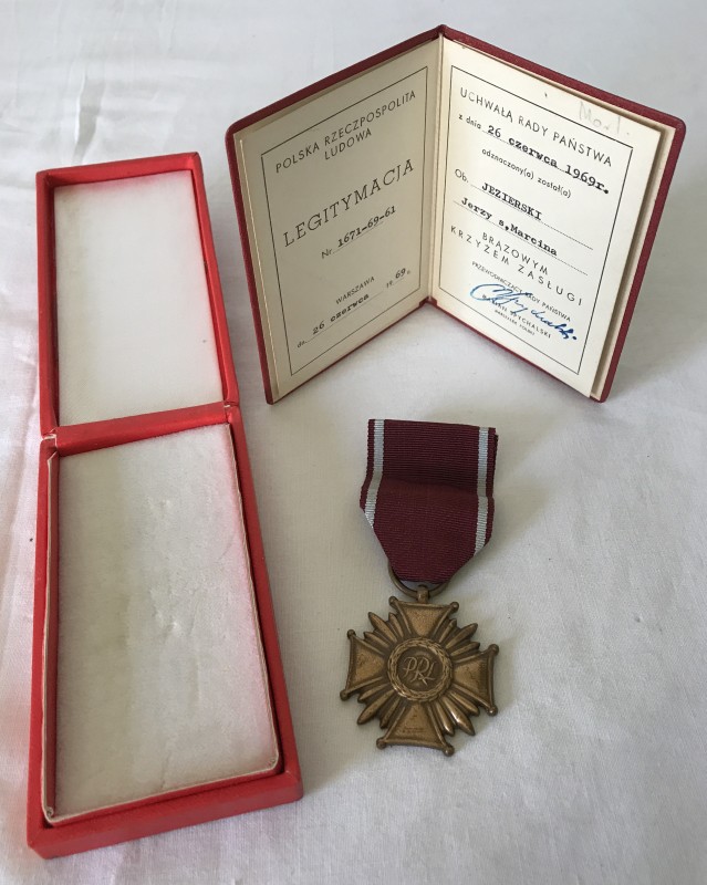 A boxed Polish Cross of Merit with certificate, bronze award.