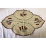 Embroided cloth centre piece for dining table showing British, French, Belgian & Serbian flags.