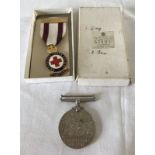 A 1939-45 Defence Medal (without ribbon) with a boxed British Red Cross 3 Year's Service Medal.