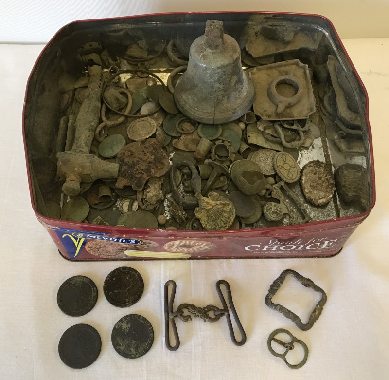 A tin of assorted coins and misc items.