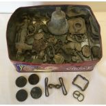 A tin of assorted coins and misc items.