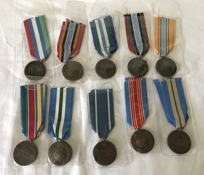 10 United Nations medals with different ribbon types.