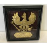 An Imperial German Pickelhaube plate, framed.