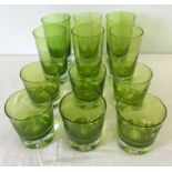 A set of 12 green hand blown glasses. With bubble design to base.