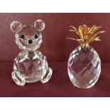 2 Swarovski crystal ornaments. A teddy bear together with a pineapple with 24 carat gold plated top.