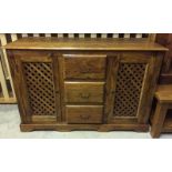 A large Indian rubber wood triple sideboard with 2 cupboards and central drawers.