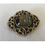 A vintage decorative mourning brooch set with central polished natural agate.