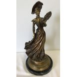 A bronzed effect metal lady figure, in period dress.