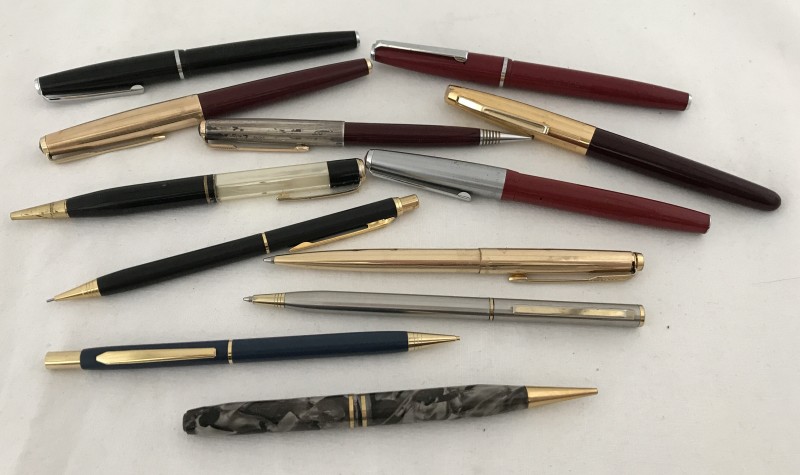 A quantity of fountain pens, ball point pens and propelling pencils.