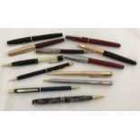 A quantity of fountain pens, ball point pens and propelling pencils.