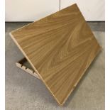 A modern light wood table top sloping drawing board.