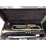 A cased Yamaha trumpet together with a quantity of music.