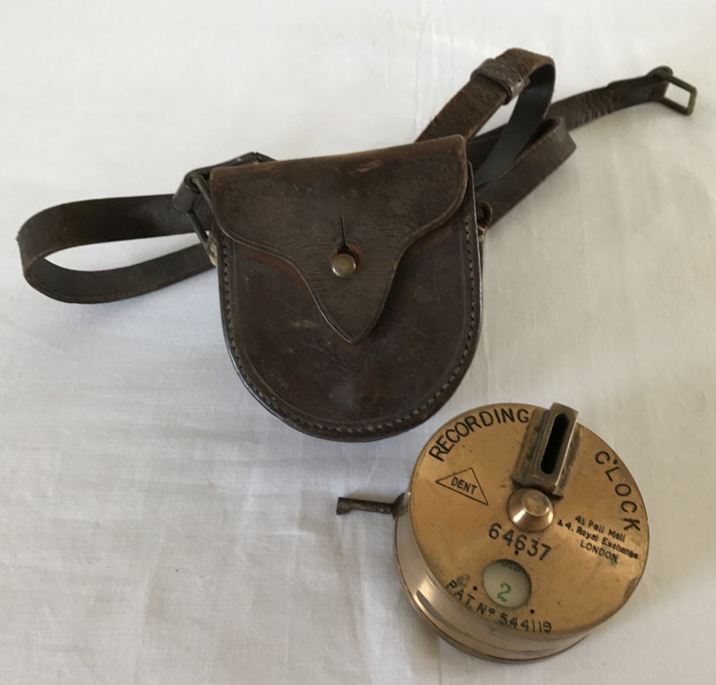 A vintage brass night watchman's recording clock with leather case.