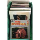 A box containing a large quantity of vintage vinyl records.