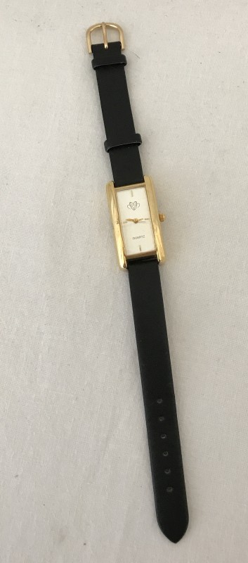 Quartz ladies watch with black leather strap.