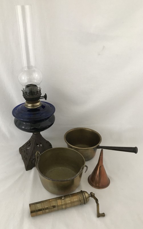 A vintage oil lamp and brassware.