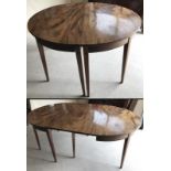 A Victorian circular extending dinning table with tapered leg.