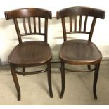 A pair of dark wood kitchen chairs.