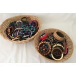 2 wicker baskets containing a large quantity of costume jewellery.