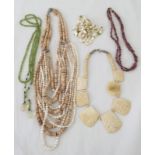 5 necklaces featuring stones, shells and carved bone.