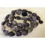 3 strings of large, polished amethyst stones.