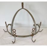 A vintage metal wall hanging kitchen rack.