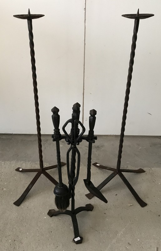 Cast iron fireside companion together with a pair of cast iron candle stands.