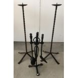 Cast iron fireside companion together with a pair of cast iron candle stands.